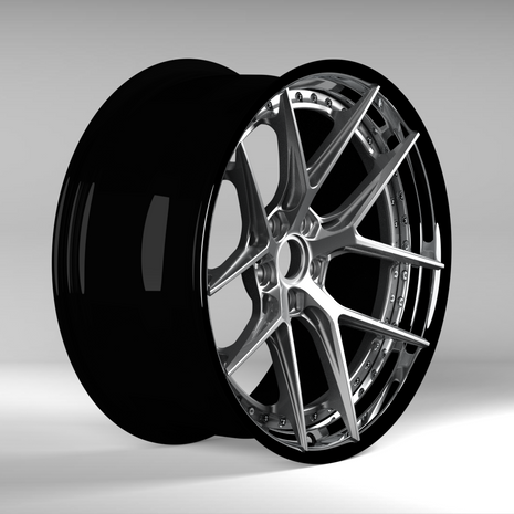 Black alloy wheel on a gray background