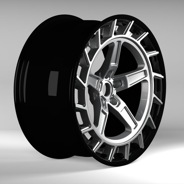 Black alloy wheel on a gray background