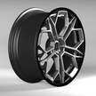 Black alloy wheel on a gray background