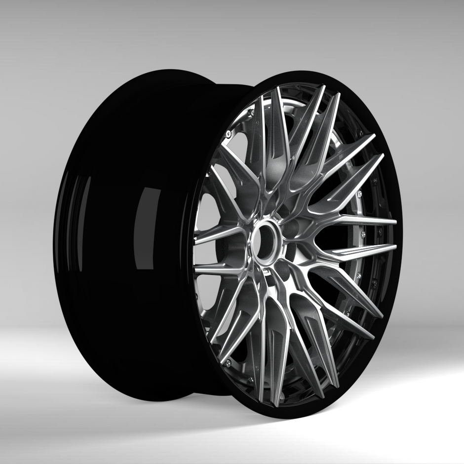 Black alloy wheel on a gray background