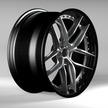 Black alloy wheel on a gray background
