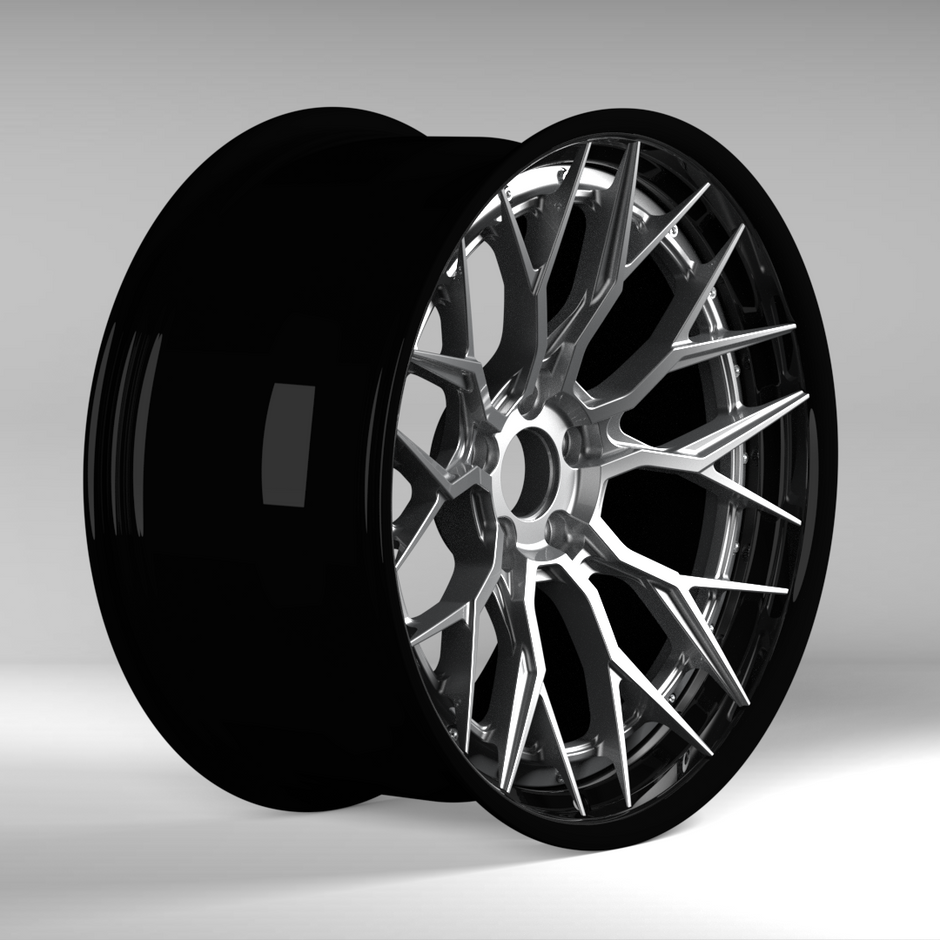 Black alloy wheel on a gray background