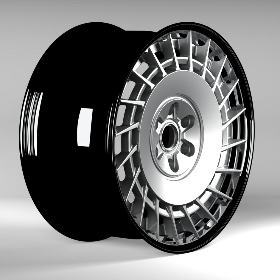 Close-up of a black and silver wheel on a gray background