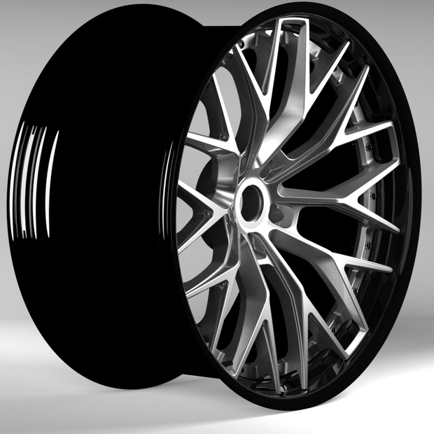 Car wheel rim with black and silver finish on a gray background