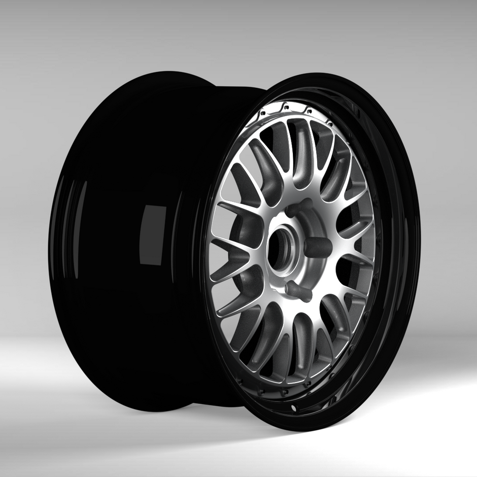 Black alloy wheel on a gray background